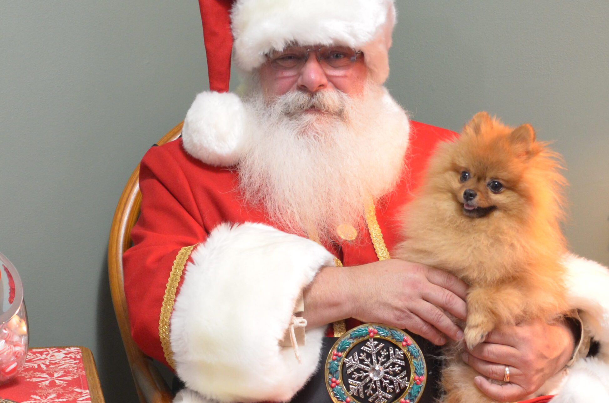 Santa Tom seated, posing with Tinker the Pomeranian