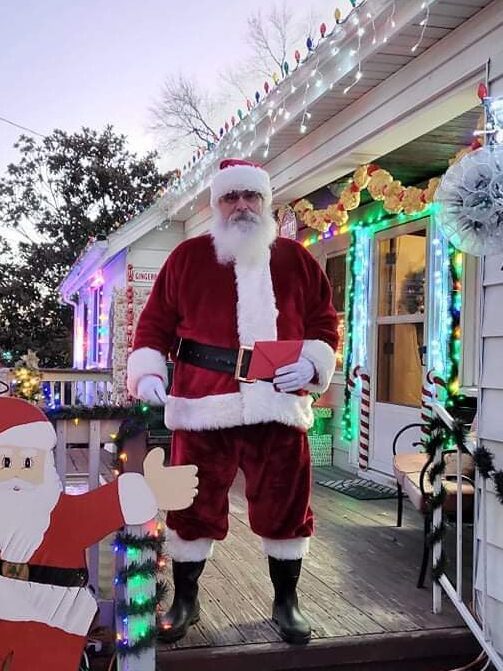 Santa Tom departing a decorated home after a Christmas visit