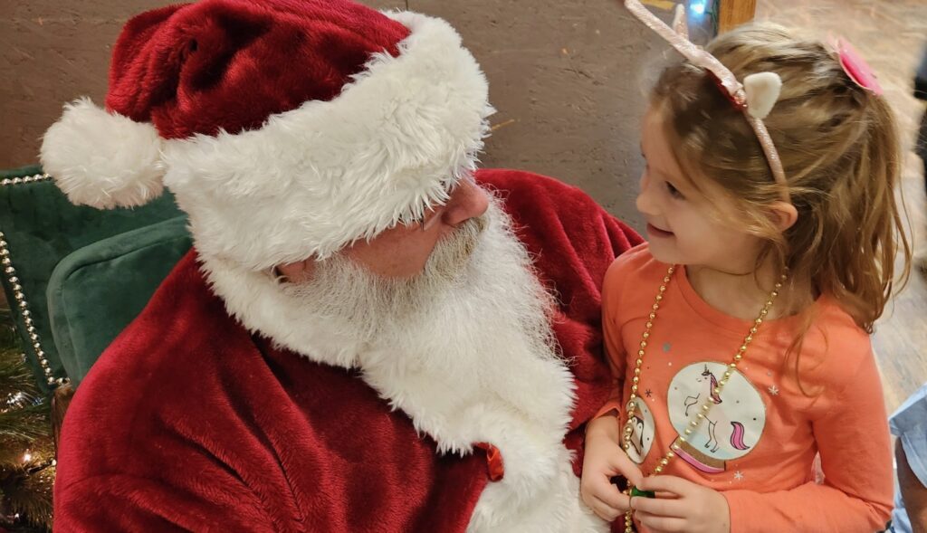 Santa Tom having a conversation with a young girl